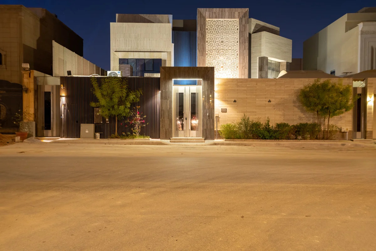 Contemporary exterior with glass facade at dusk.